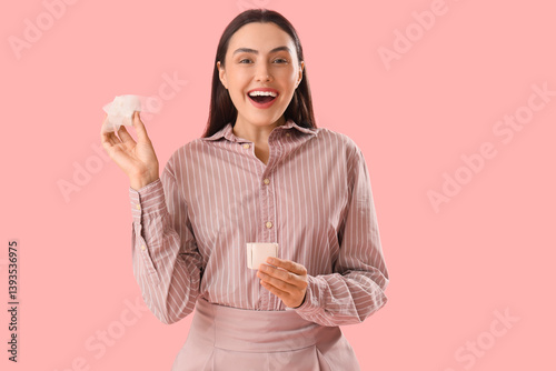 Excited young woman holding...
