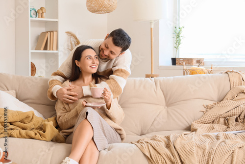 Happy young couple with cup...