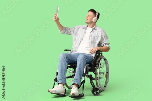 Young man in wheelchair wit...
