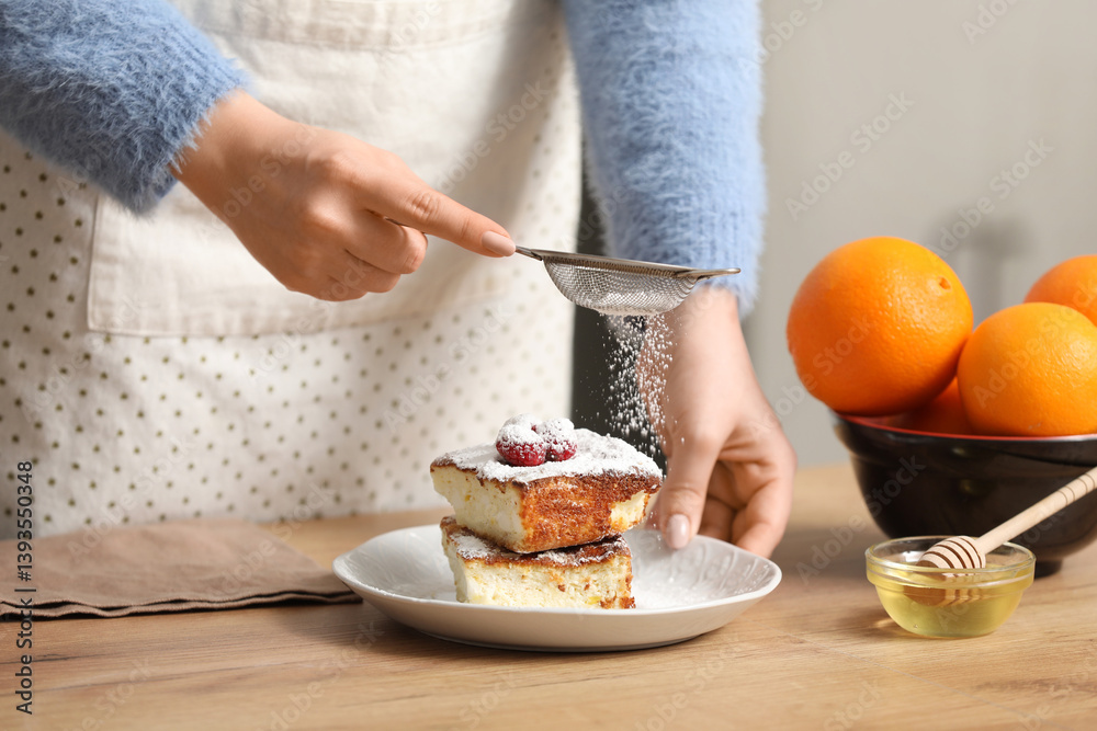 Woman decorating delicious cake with sugar powder in kitchen. Closeup Woman decorating delicious cake with sugar powder in kitchen. Closeup