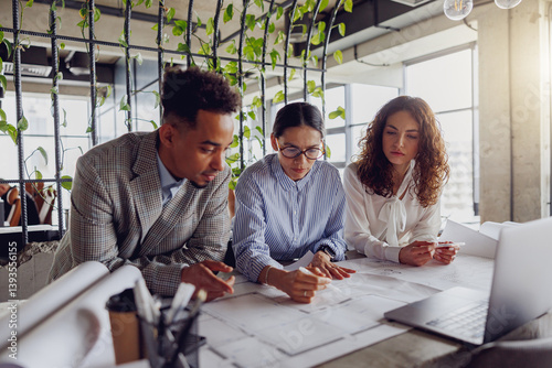 A diverse and talented team working collaboratively on innovative architectural plans within a modern workspace