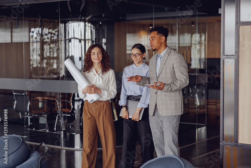 Wallpaper Mural A diverse team of professionals is actively discussing their plans in a modern, innovative office setting Torontodigital.ca