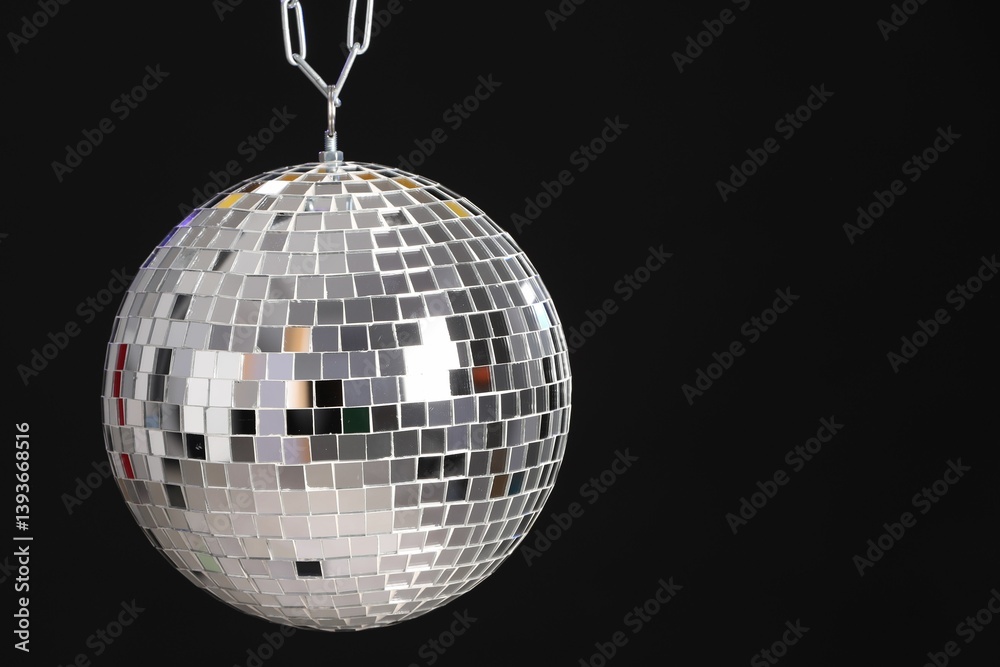 One shiny disco ball on black background, space for text