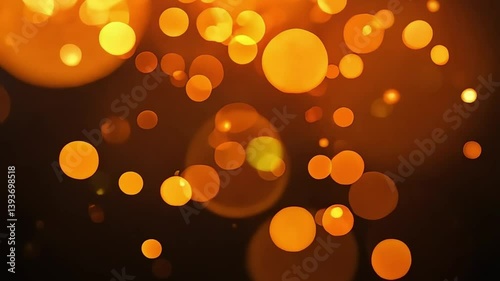 Abstract animation featuring warm orange bokeh light particles floating on a dark background, evoking a festive and cozy mood.