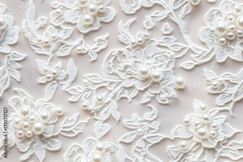 Seamless intricate white Beaded lace fabric with floral patterns and pearl embellishments, ideal for bridal or formal wear.