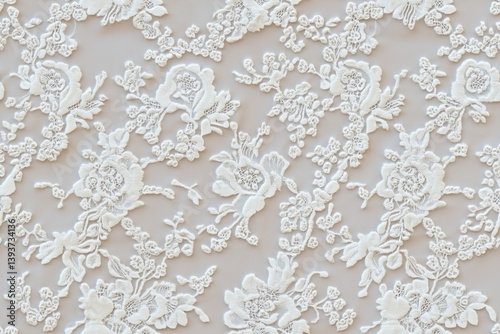 Seamless intricate white Lourdes lace fabric featuring floral patterns and delicate embroidery. The lace has a soft, elegant appearance, suitable for bridal wear or formal attire.