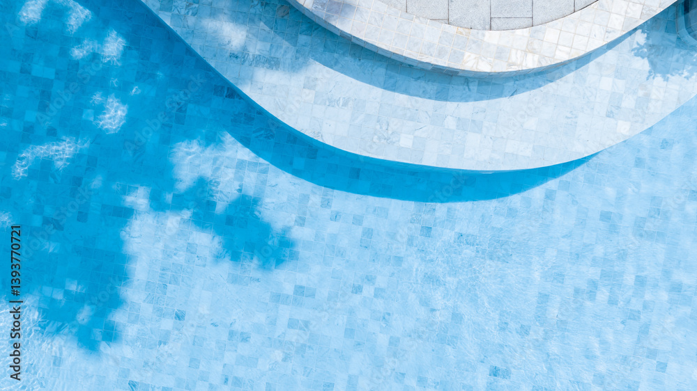 Top view swimming pool blue water in summer with umbrella pool and deck beach chair, Empty swimming pool with sunbed and umbrella pool in resort hotel for vacation leisure, Summer vacation holiday.
