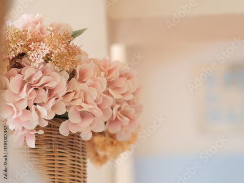 bouquet of pink roses. Beautiful bunch of artificial flower in wooden basket. Famous decoration interior design in restaurant.