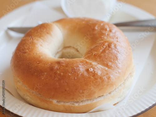 Bagel with cream cheese. Classic Baked Bagel bread serving on the plate. Famous quick and easy flour breakfast menu in restaurant.
