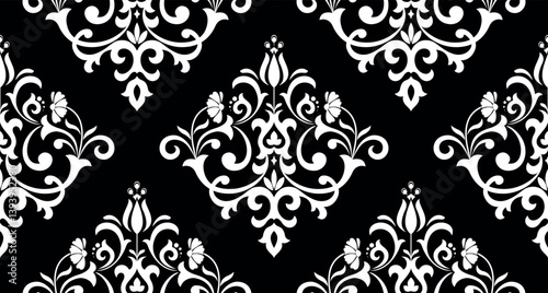 Wallpaper in the style of Baroque. Seamless vector background. White and black floral ornament. Graphic pattern for fabric, wallpaper, packaging. Ornate Damask flower ornament.