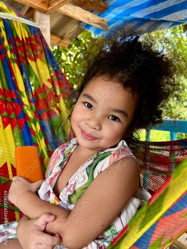 Portrait of a cute Asian little girl in hammock