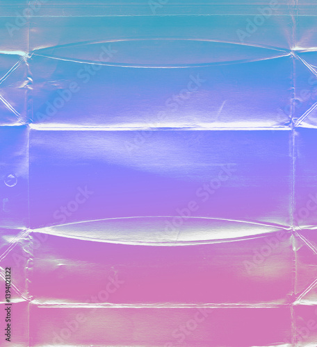 Holographic foil texture with Iridescent colors. Multicolored background - metallic plastic-coated food packaging - abstraction for creative poster, experimental design, music banner or cover