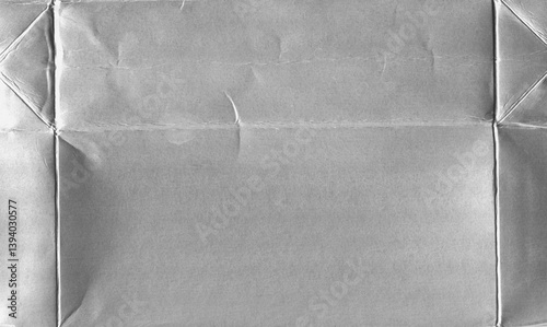 Milk package die-cut - crumpled silver foil texture with folded package. Metallic plastic-coated food packaging for background of creative poster designs, banners or covers