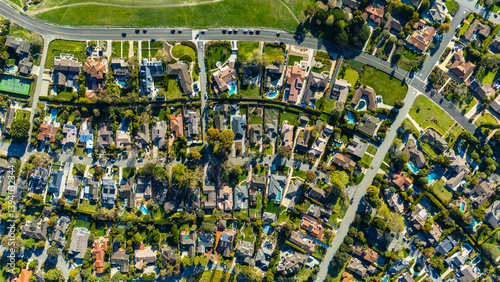 Top-down drone shot of a suburban neighbourhood in Rancho Palos Verdes, California. The image shows residential homes with green lawns, trees, and organized streets in Los Angeles County.


