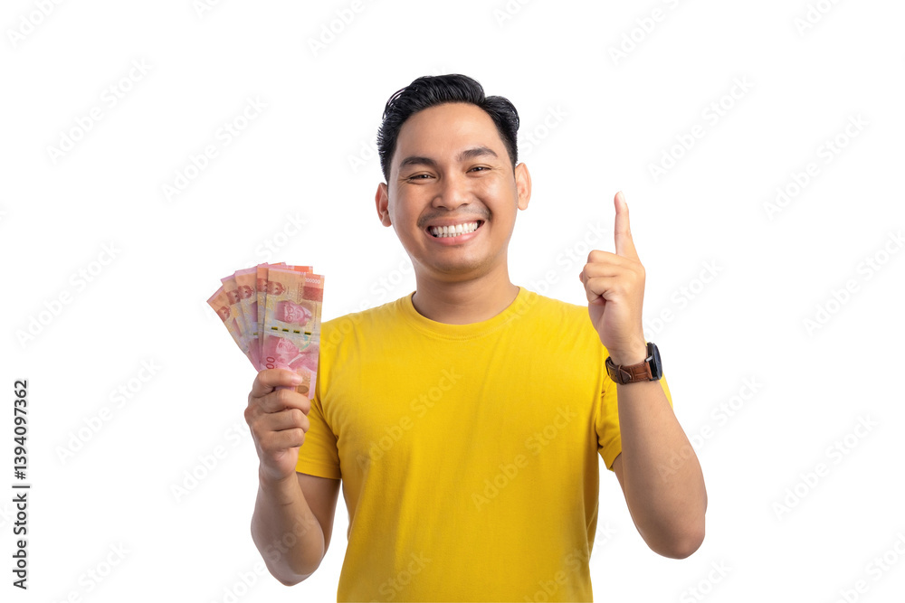 Smiling young Asian man holding money and pointing finger up with happy expression isolated on transparent background Smiling young Asian man holding money and pointing finger up with happy expression isolated on transparent background