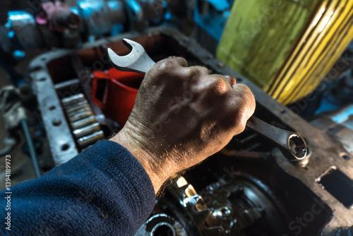 repair of an old blue tractor in a vintage garage, dismantling and installation of a gearbox, replacement of bearings