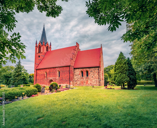 Obraz na płótnie Adorable summer view of red briks St.-Johannis Church. Gorgeous morning cityscape of Kruckow village, Germany, Europe. Traveling concept background. w salonie