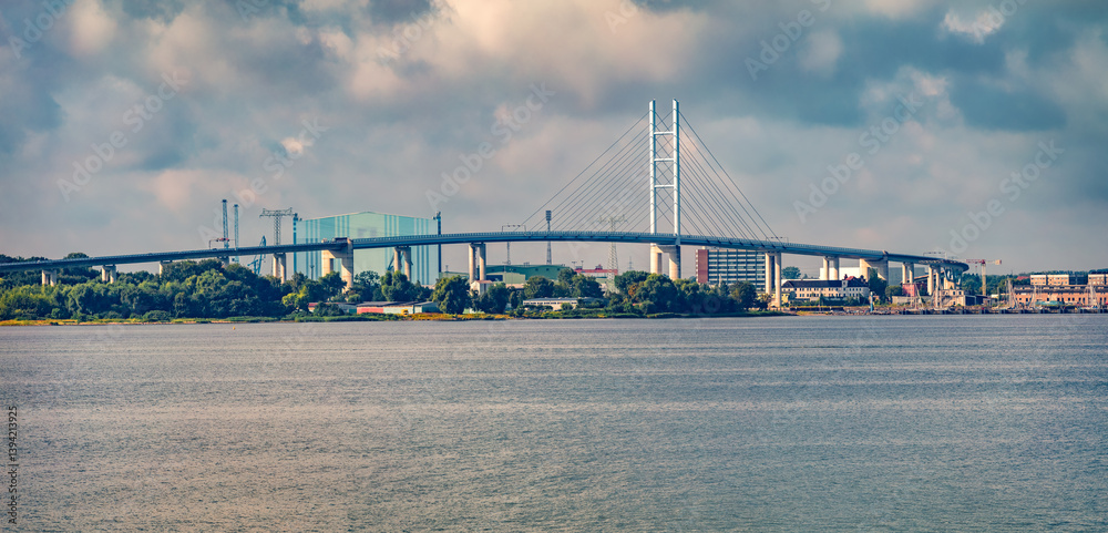 Panoramic summer cityscape of Stralsund town with Rugendammbrucke chain bridge, Germany, Europe. Wonderful morning seascape of Baltic sea. Traveling concept background.