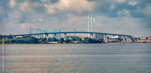 Obraz na płótnie Panoramic summer cityscape of Stralsund town with Rugendammbrucke chain bridge, Germany, Europe. Wonderful morning seascape of Baltic sea. Traveling concept background. w salonie