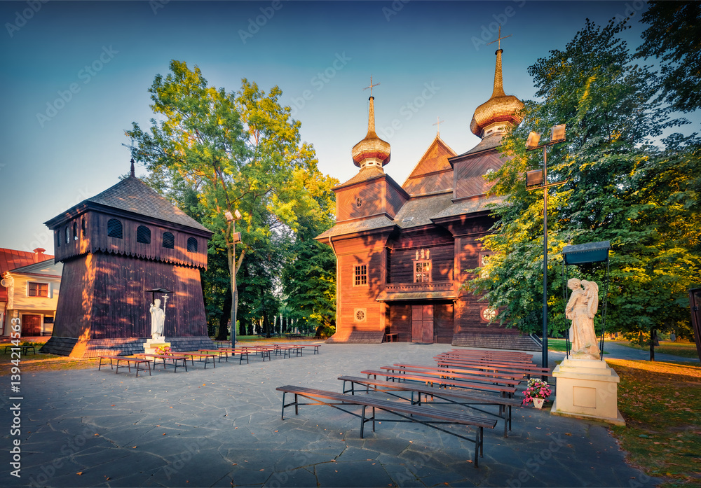 Adorable morning view of wooden Catholic Church of the Annunciation of the Blessed Virgin Mary. Exciting summser cityscape of Tomaszow Lubelski town, Poland. Traveling concept background.