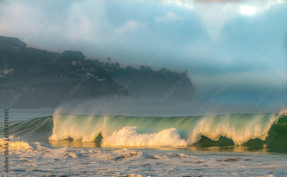 Early morning large waves pound the coastal shoreline in Southern California