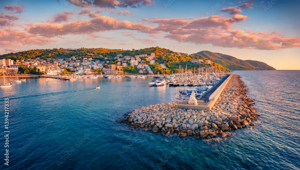 Picturesque summer sunrise on Agropoli port with a lots of yachts and stone pier, Italy, Europe. Wonderful morning seascape of Mediterranean sea. Traveling concept background.