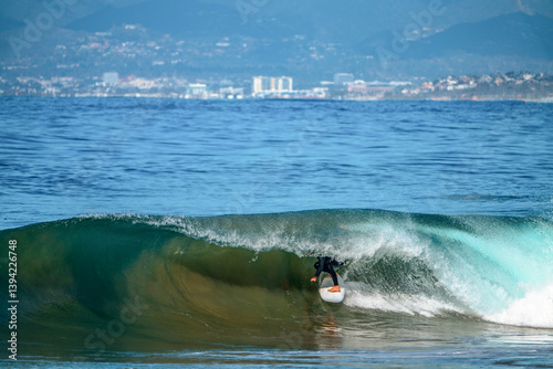 Surfer's feet and board showing through the closing of a large wave