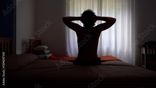 Obraz na płótnie Man wakes up in the morning and gets out of bed to open the window curtains and look out of the house ready to start a new day - lifestyle in apartment w salonie
