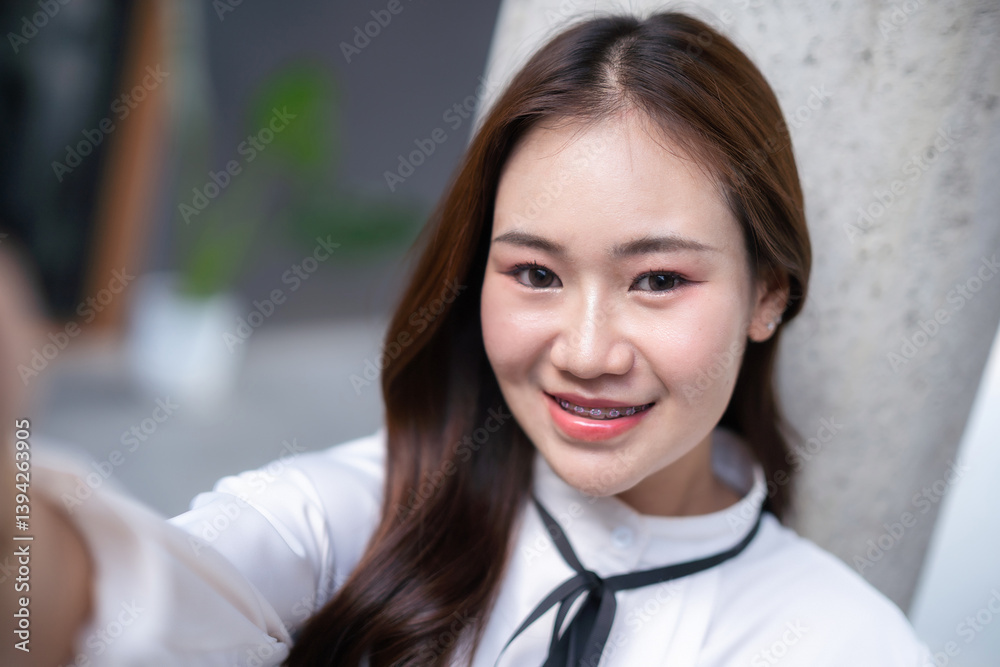 Portrait of beautiful happy Smiling asian woman Take a selfie with a smartphone relaxing sitting in cafe interior in coffee shop background,Business Lifestyle summer holiday concept