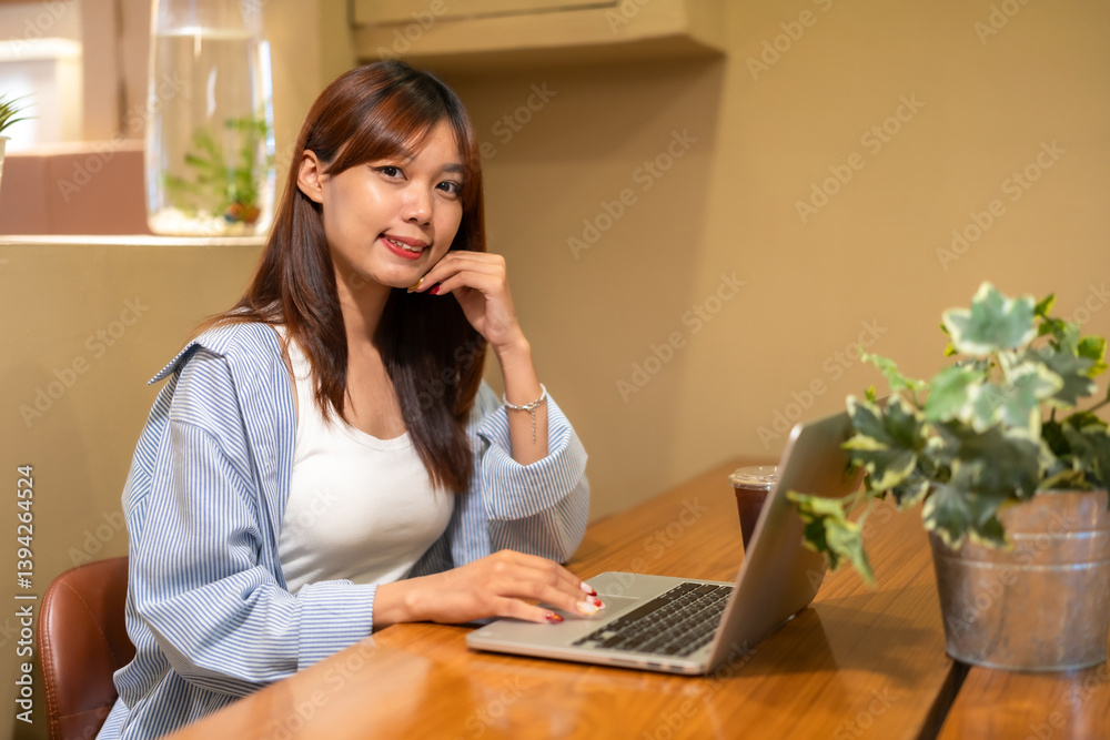 Portrait of asian freelance teenage people business woman casual working with laptop computer in cafe interior in coffee shop background,business expressed confidence embolden and successful concept