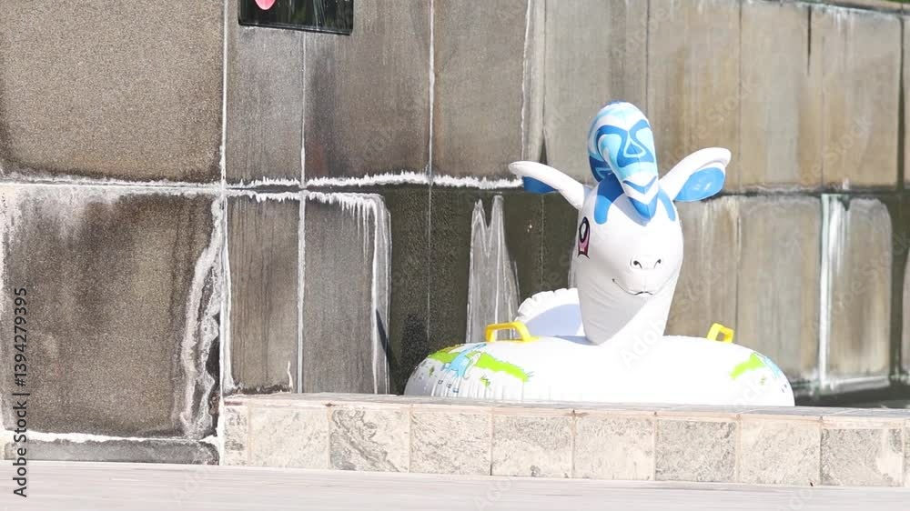 Inflatable Unicorn Near Poolside Wall