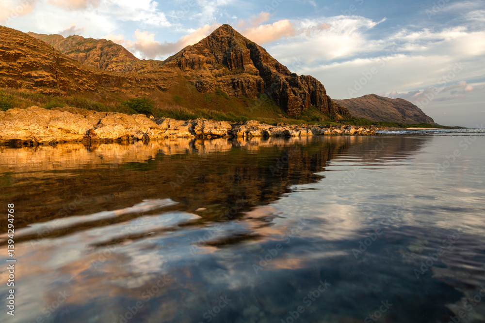 Calm sunset reflection at Keawaula Bay on the west coast of Oahu, Hawaii. Calm sunset reflection at Keawaula Bay on the west coast of Oahu, Hawaii.