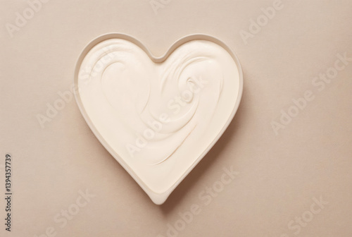 White cosmetic cream in heart-shaped packaging, top view. Cosmetic product for facial skin care
