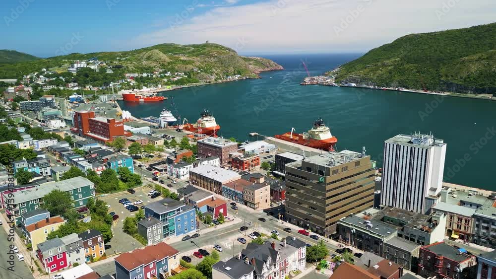 A slow fly over Duckworth street in St. John's, Newfoundland, Canada on a Summer day displaying the harbour and Signal Hill.
