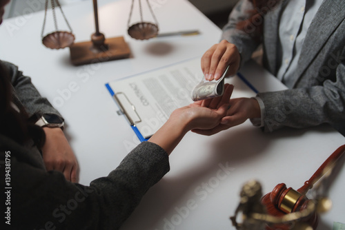 Foto Businesswoman handing rolled-up dollar bills as bribe money to corrupt lawyer in