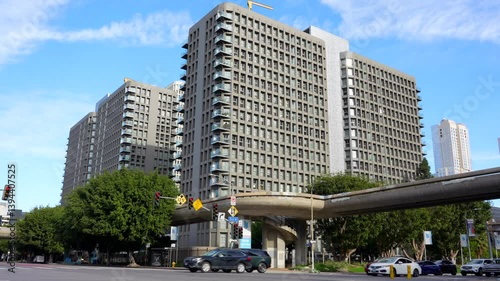 Los Angeles, California - January 7, 2025:Street view of the Skye at Bunker Hill apartments complex, showcasing modern architectural design in downtown LA with traffic and greenery