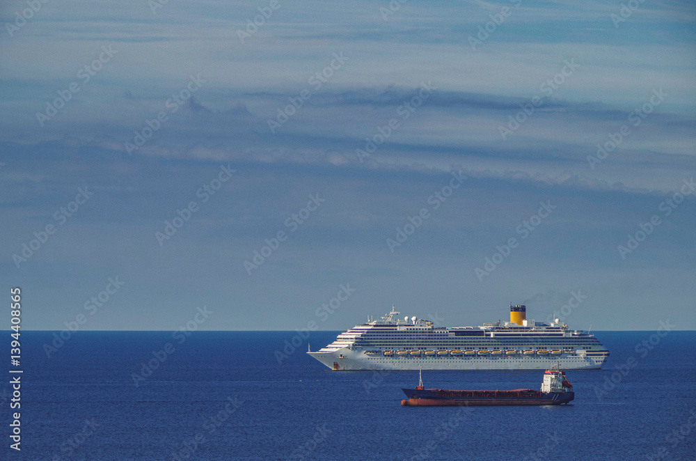 Mega family cruiseship cruise ship liner Favolosa and bunker ship anchored offshore of Civitavecchia Rome, Italy before reactived after Covid pandemic with other vessels in port and coastline