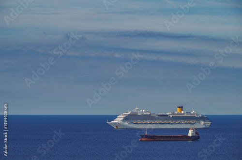 Obraz na płótnie Mega family cruiseship cruise ship liner Favolosa and bunker ship anchored offshore of Civitavecchia Rome, Italy before reactived after Covid pandemic with other vessels in port and coastline w salonie