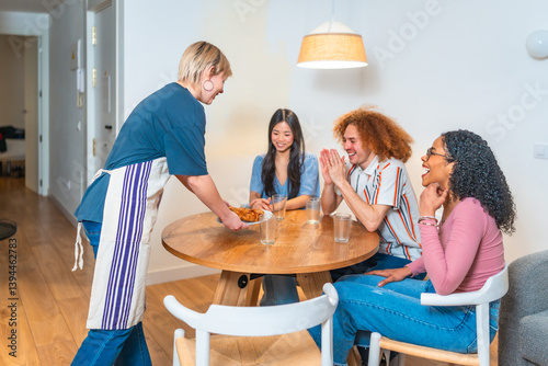 Obraz na płótnie Woman serving food to happy friends at home w salonie