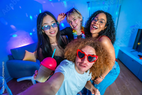 Canvas Print Friends taking selfie at home disco party with colorful lights and drinks