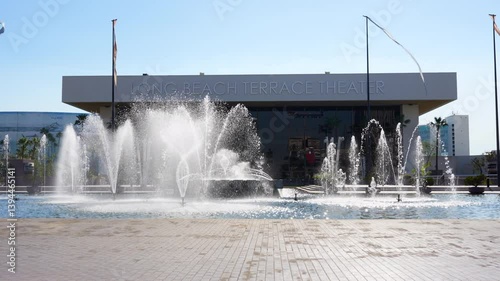 Long Beach, California - January 11, 2025: Modern Long Beach Terrace Theater is accentuated by a vibrant fountain display in a sunny atmosphere, ideal for outdoor events and performances