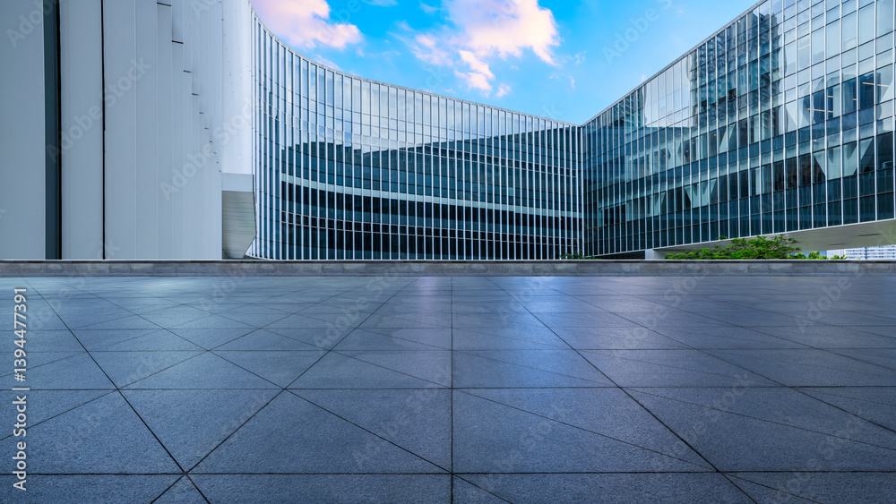 Empty square floors and glass wall with modern buildings in city landscape