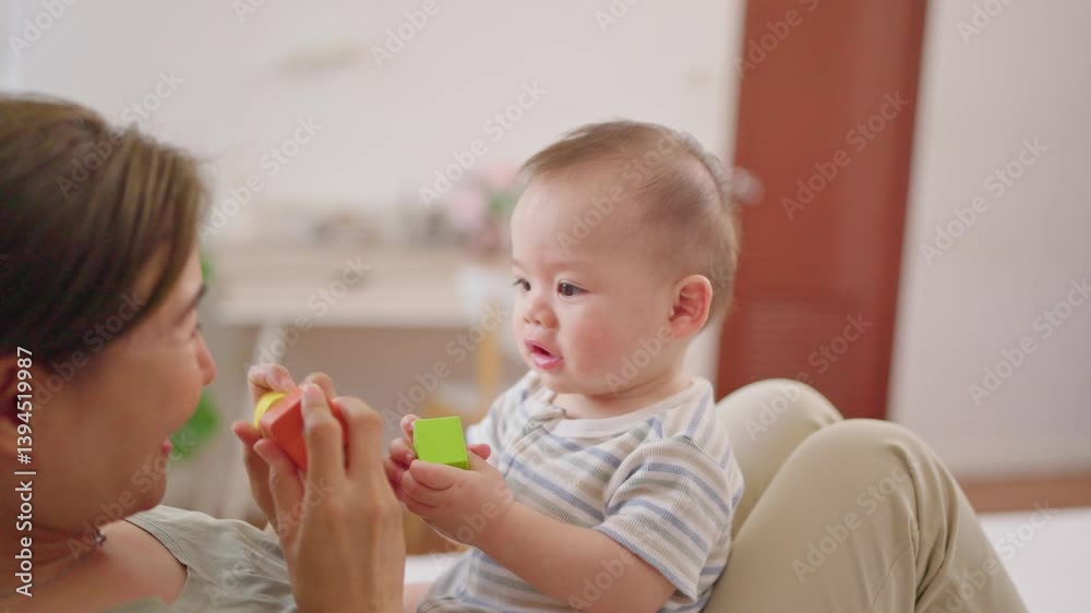 Asian single mother lovingly cares for and raises her baby boy at home. Asian single mother lovingly cares for and raises her baby boy at home.