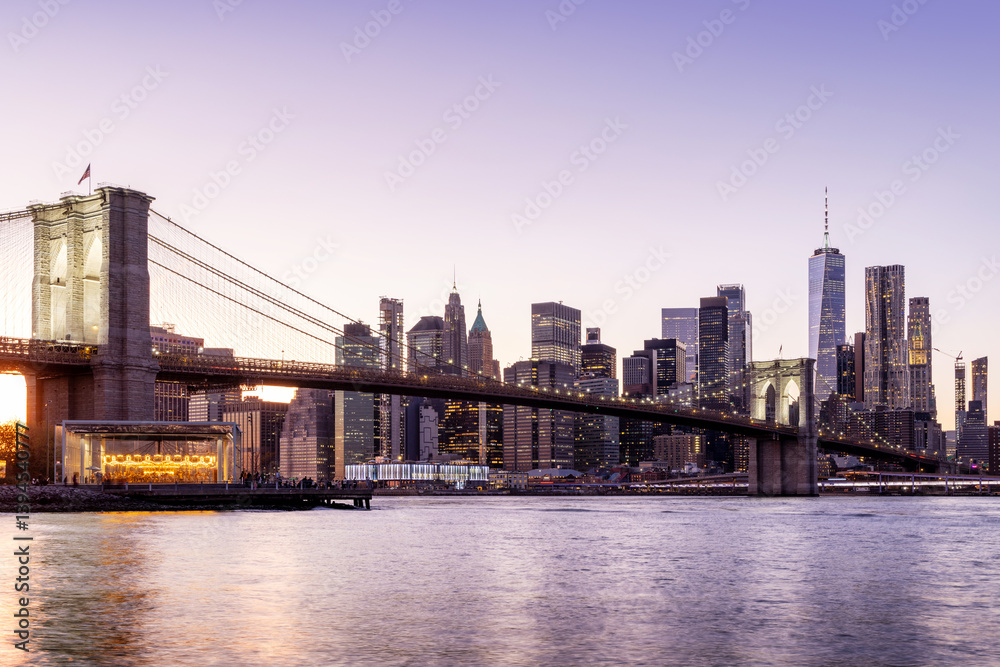 A panoramic sunset view of the Brooklyn Bridge stretching towards Manhattan A panoramic sunset view of the Brooklyn Bridge stretching towards Manhattan