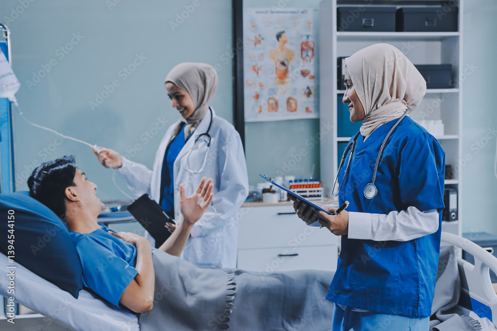 Obraz premium A young man lies on a bed in a hospital ward talking with her young Indian doctor. Doctor checking patient's health doctor treating patient, hospital admission of patient