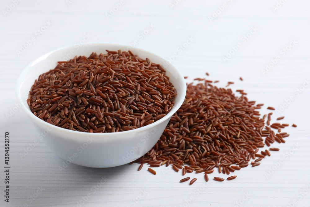 Brown rice in the bowl on white background Brown rice in the bowl on white background