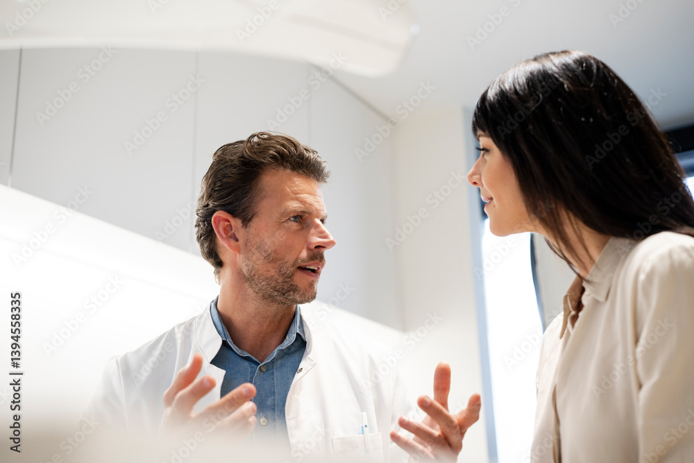 Dentist consulting with a patient in a dental office Dentist consulting with a patient in a dental office