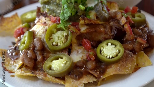 Mexican food beef nacho chips with chilli and salsa jelapeno cheese latin appetizer