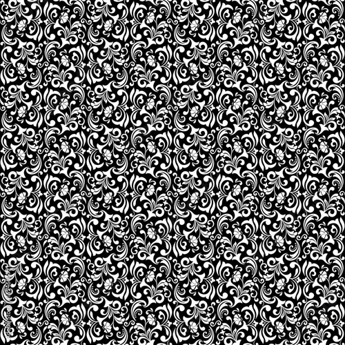 Wallpaper in the style of Baroque. Seamless vector background. White and black floral ornament. Graphic pattern for fabric, wallpaper, packaging. Ornate Damask flower ornament.