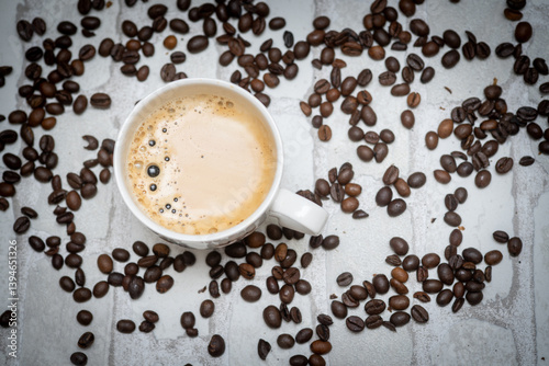 Top-down view of a delicious cup of coffee next to scattered coffee beans—perfect for café promotions, morning routines, and coffee lover content. Warm, inviting, and full of aroma.